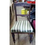 A set of four Edwardian walnut dining chairs with upholstered seats