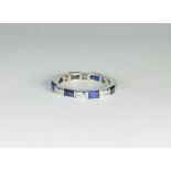 A sapphire and diamond full eternity ring on a platinum band,