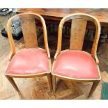 A set of six 1920s walnut framed rounded backed dining chairs with red upholstered seats