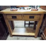 A heavy light oak side table fitted 2 drawers,