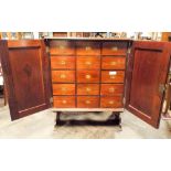 A Victorian mahogany two door cabinet fitted fifteen interior draws,