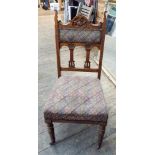 A set of 4 Edwardian oak framed dining chairs with tapestry upholstered seats and backs