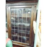 A reproduction oak bookcase with leaded glazed door,