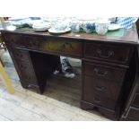 A reproduction mahogany pedestal desk, fitted nine drawers with green leather top,