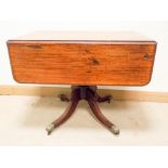 A Victorian Duncan Phyfe style mahogany Pembroke table on pillar and quadruple base with brass paw