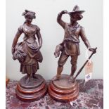 A pair of Victorian spelter figure ornaments of a hunter and a corn gather,