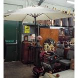 A new wind up large garden parasol in beige with heavy stabilising base
