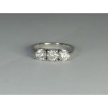 A three stone diamond ring, set with three circular brilliant cut diamonds weighting 1.