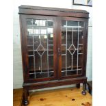 An oak bookcase with leaded glazed door 3' wide