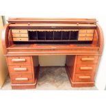 A Victorian mahogany cylinder top knee hole desk with double pedestals each fitted three draws with