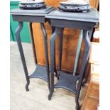 A pair of two tier dark stained plat pedestals