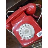 A red bakelite dial telephone