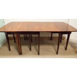 A Georgian mahogany three section extending dining table on square legs with spade feet,