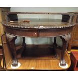 An Edwardian oval mahogany extending dining table with leaf and handle standing on cabriole style