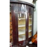 A Georgian wall hanging bow front corner display cabinet with two glass doors and small drawer