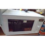 A Panasonic inverter microwave oven in a white case