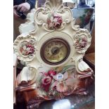 A large Victorian mantel clock in floral decorated China case