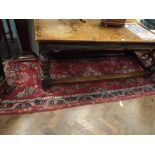 A long red Persian patterned, wool pile carpet runner,