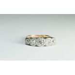 Five stone diamond ring on a carved setting on an 18ct gold and platinum shank.