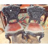 A pair of Chinese carved hardwood hall chairs on cabriole style legs with wood panel legs