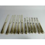 A set of six silver bladed and handled pastry knives and forks.