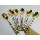 A set of six Victorian silver gilt teaspoons with decorative open lattice work handles.