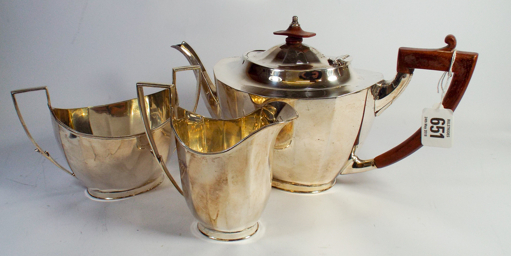A three piece silver tea service, of panelled classical design, retailed by Mappin & Webb,