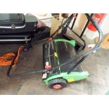 A Florabest push along lawn mower with grass box and scarifyer attachment