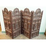 A pair of carved indian two fold fire side screens