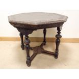 A late Victorian octagonal carved dark oak centre table with small under tier on turned legs