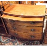 A Regency period mahogany bow front bachelors chest of draws, fitted with three long draws and side,