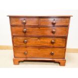 A late Georgian mahogany chest of three long and two short draws with Victorian bun handles,