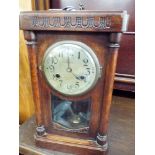 An Edwardian striking mantel clock in an oak case