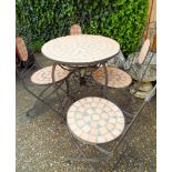 A circular iron framed garden table with tile effect top and four matching folding chairs