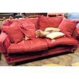 A two seater Knoll settee in red material with loose cushions