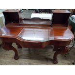 A Victorian mahogany shaped topped dressing table on cabriole style legs (no mirror)