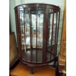 A mahogany D shaped glazed china display cabinet on cabriole feet