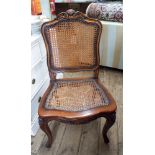 Reproduction mahogany framed office or dining chair with cane panelled seat and back standing on