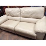 A modern two seater reclining settee in cream leather with one matching chair