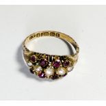 Two 9ct gold garnet set dress rings and a seed pearl antique ring on 9ct closed back setting