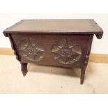 A small antique style oak blanket chest with circular carved panels,