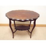 An oval pie crust edge two tier mahogany Edwardian occasional table