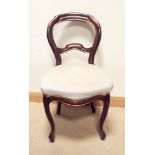 A set of four Victorian mahogany bloom back dining chairs with spring fawn upholsters seats