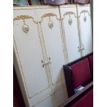 A pair of 2'6" cream and gilt decorated two drawer wardrobes