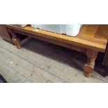 A long heavy pine coffee table on turned legs
