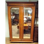 A French inlaid kingwood armoire with two mirrored doors,