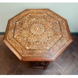 A Moorish octagonal bone inlaid occasional table with folding base 50 cms diameter,