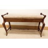 An Edwardian walnut duet stool with fawn upholstered standing on cabriole style legs