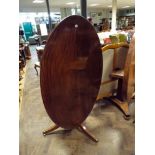 A Georgian oval mahogany snap over top breakfast or dining table 145 cms tall top