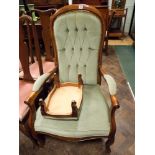 An elbow chair in button green dralon with matching footstool